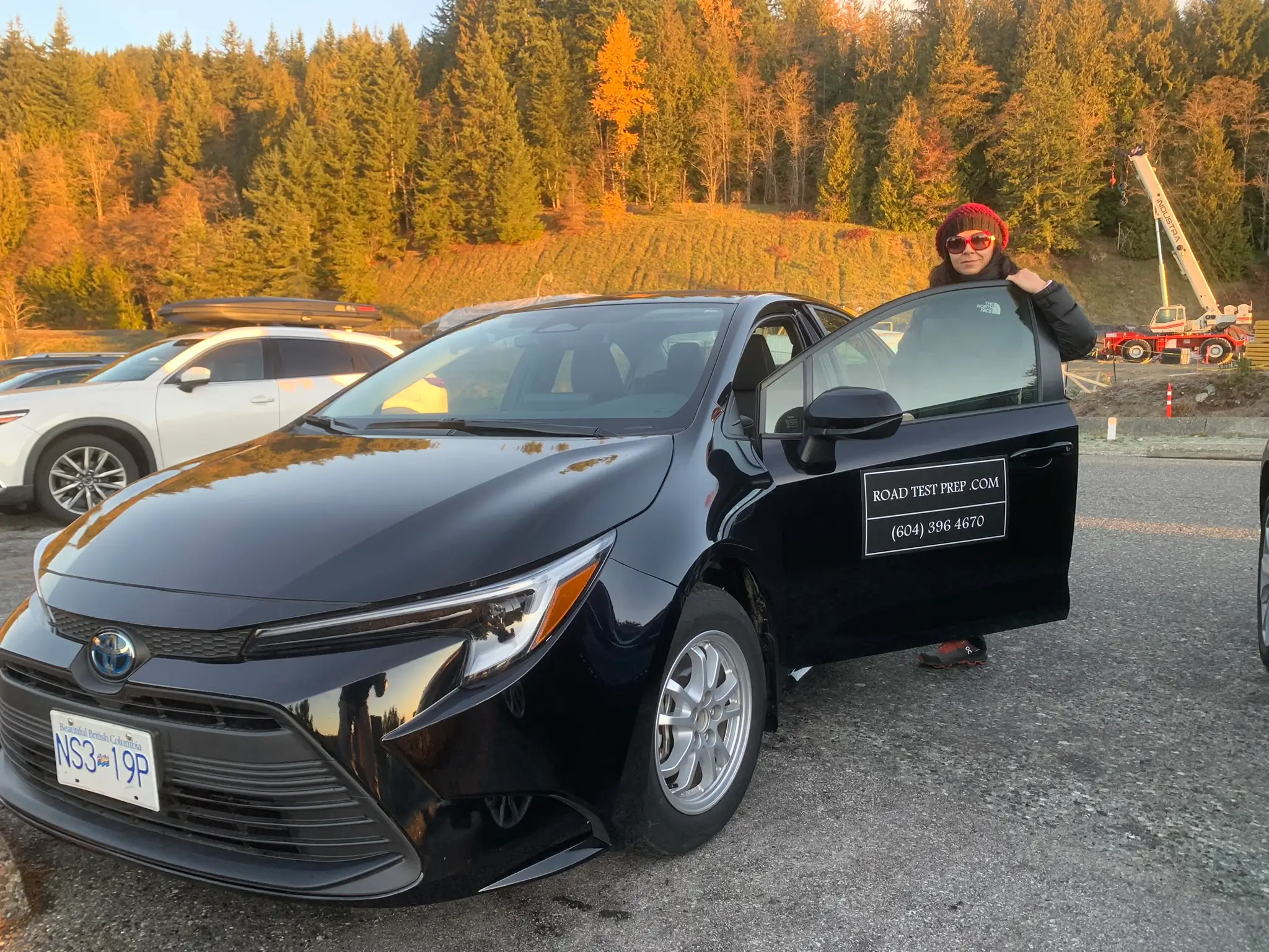 Black Toyota Corolla with Orca Road Test Prep Branding in Vancouver