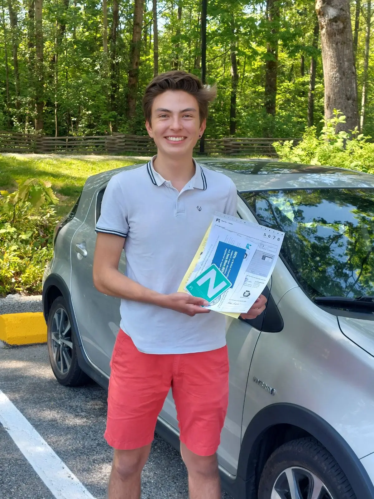 Happy New Driver in Vancouver Holding “N” Sign and Driving Documents